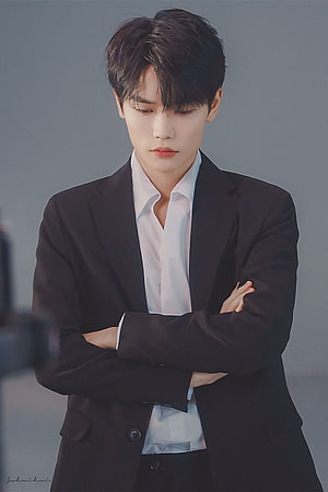 Young Asian man in a black suit and white shirt with arms crossed against a grey studio background HD phone wallpaper