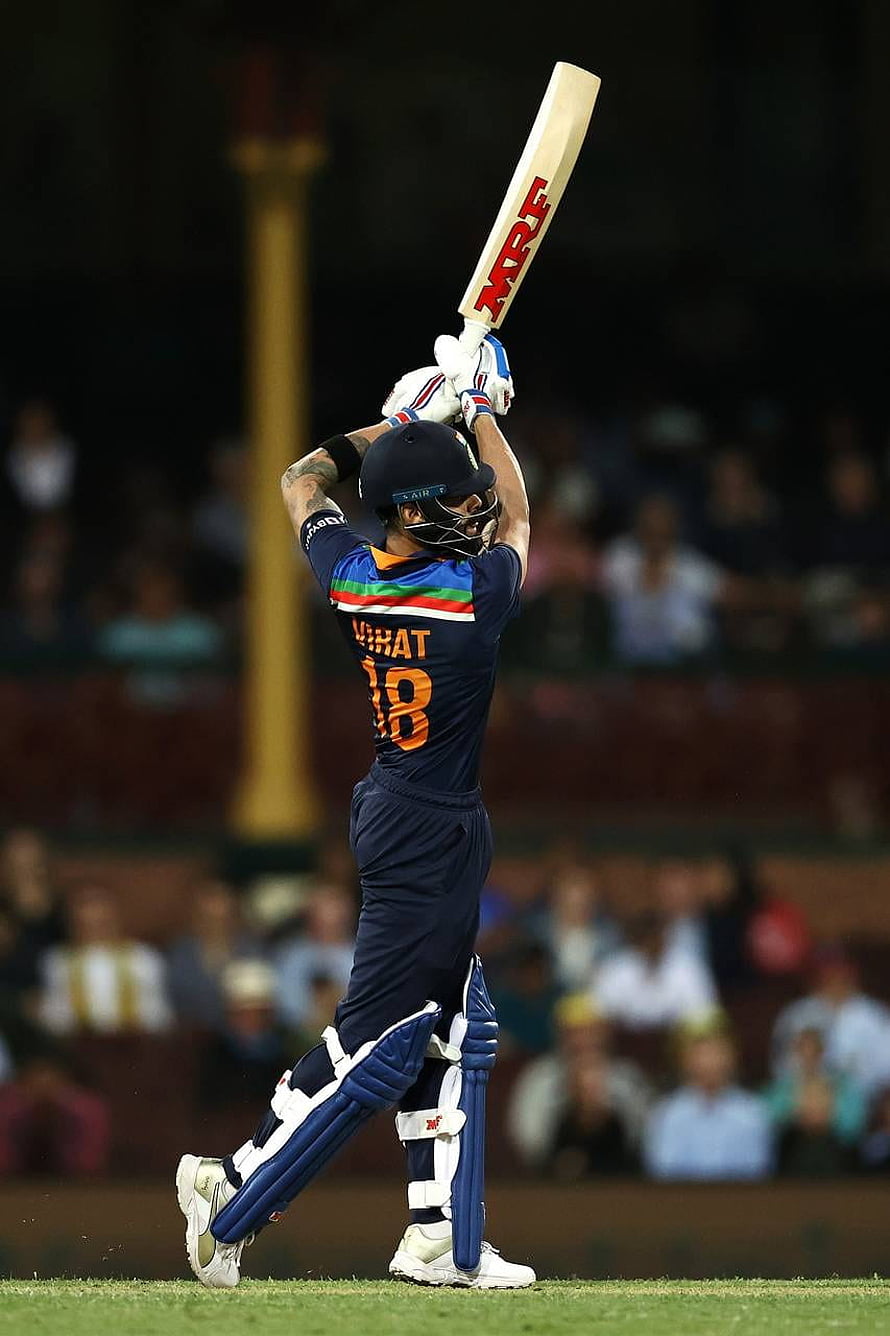 Virat Kohli in India Test Kit Raising Cricket Bat in Celebration at Night HD phone wallpaper