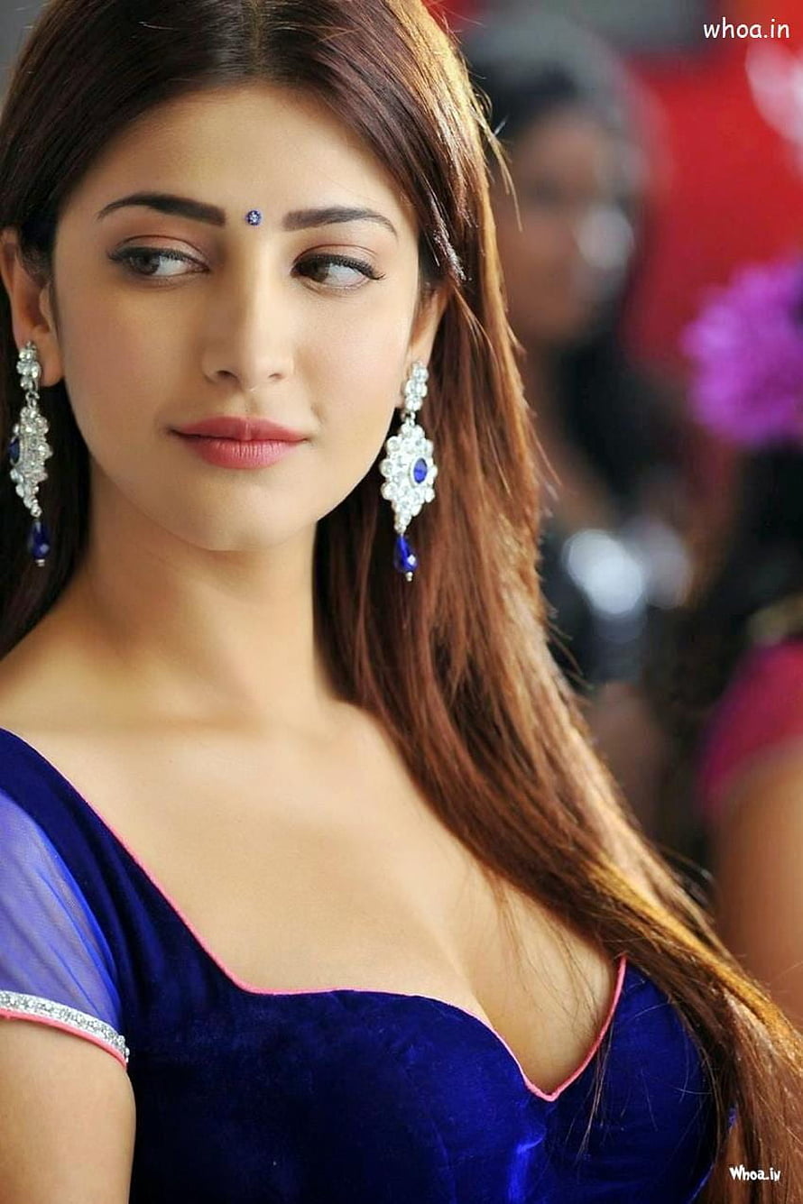 Shruti Haasan in a deep blue velvet gown with ornate diamond and sapphire earrings HD phone wallpaper