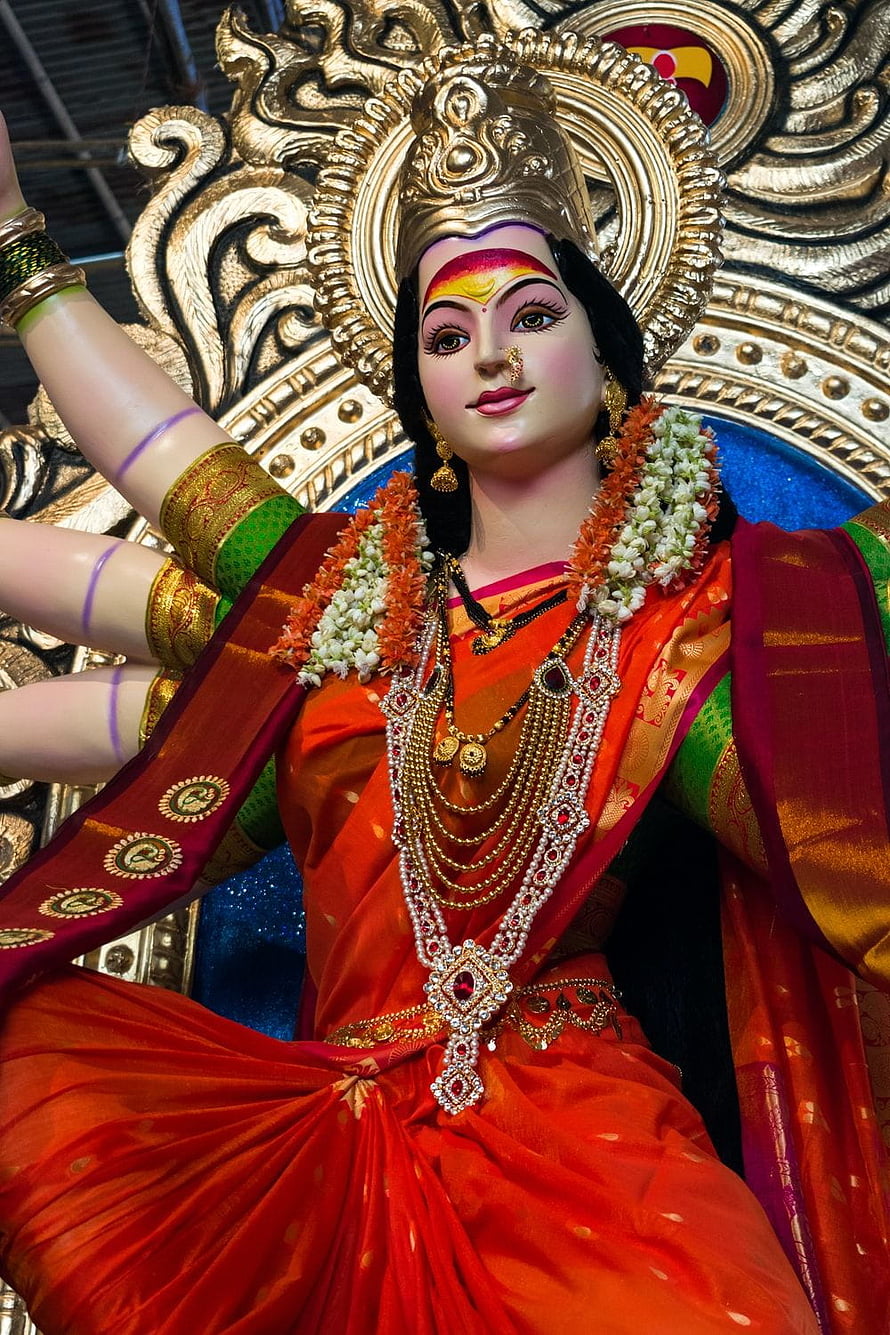 Ornate Durga Bhavani Devi Statue in Vibrant Red Saree with Gold Jewelry and Floral Garland HD phone wallpaper
