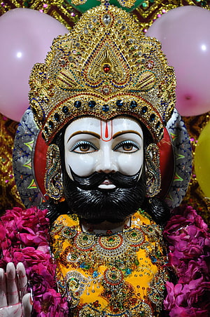 Ornate Ramdev Ji Murti with Golden Crown and Floral Garlands HD phone wallpaper