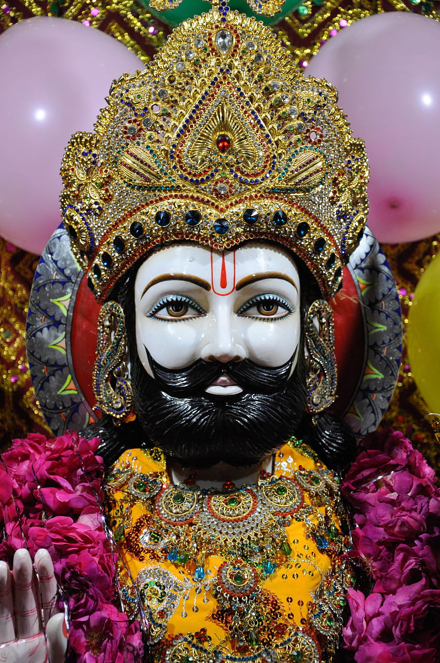 Ornate Ramdev Ji Murti with Golden Crown and Floral Garlands HD phone wallpaper