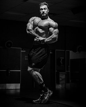 Chris Bumstead Black and White Bodybuilding Pose in Gym HD phone wallpaper