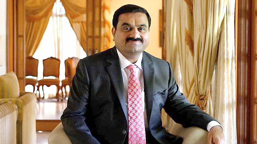 Gautam Adani in a dark suit and pink tie seated in an elegant formal room HD wallpaper