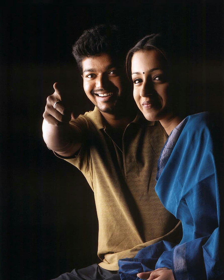 Vijay and Trisha in Saravenavelu promotional portrait with warm studio lighting HD phone wallpaper