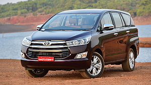 Dark Maroon Toyota Innova Crysta MPV Parked on Red Dirt Near a Lake HD wallpaper