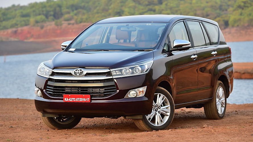 Dark Maroon Toyota Innova Crysta MPV Parked on Red Dirt Near a Lake HD wallpaper