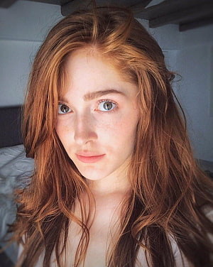 Close-up portrait of a young woman with long wavy auburn hair and freckles HD phone wallpaper