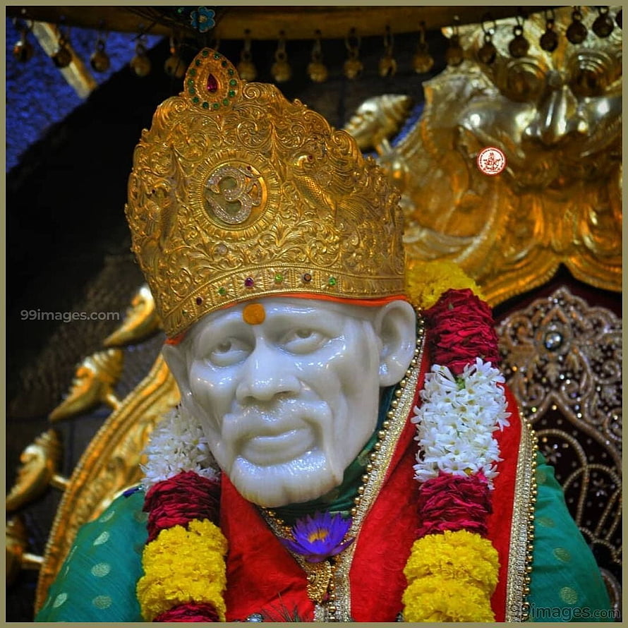 Sai Baba of Shirdi statue adorned with a golden crown and vibrant flower garlands HD phone wallpaper