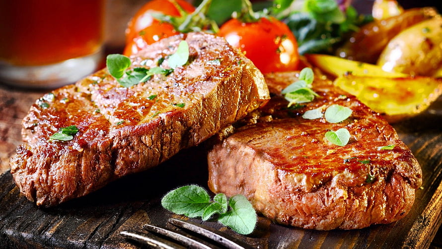 Grilled Beef Steak with Fresh Herbs and Roasted Vegetables on a Rustic Wooden Board HD wallpaper