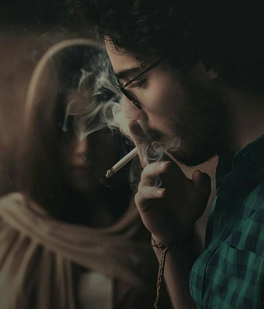 Moody Portrait of a Bearded Man Smoking a Cigarette in Dim Light HD phone wallpaper
