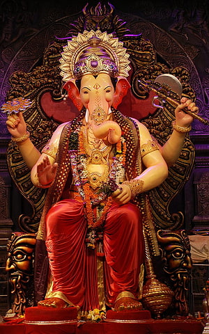 Lalbaugcha Raja Ganesha Murti in Ornate Temple Setting with Red Drape and Gold Crown HD phone wallpaper
