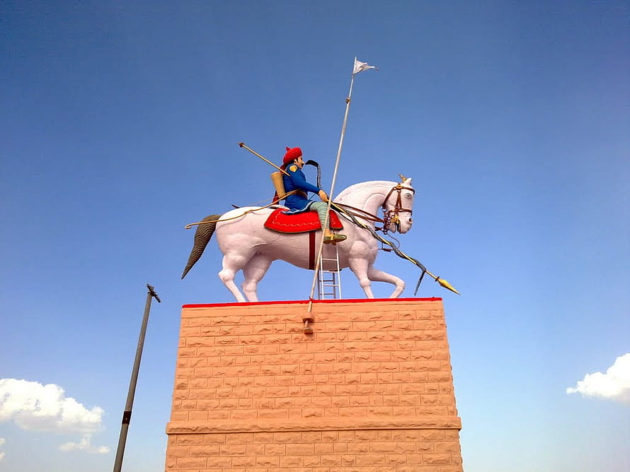 Veer Teja Ji Equestrian Statue on Brick Pedestal Under Clear Blue Sky HD wallpaper