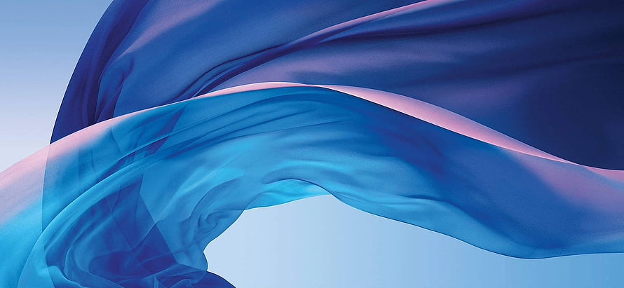Flowing Blue and Purple Silk Fabric Against a Soft Gradient Sky HD wallpaper
