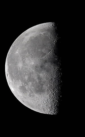 Half Moon Phase with Cratered Surface and Dark Space Background HD phone wallpaper