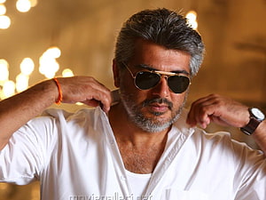 Ajith Kumar in White Shirt and Aviator Sunglasses with Warm Bokeh Background HD wallpaper