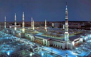 Grand Mosque in Medina at Night with Illuminated Minarets and Prayer Courtyard HD wallpaper