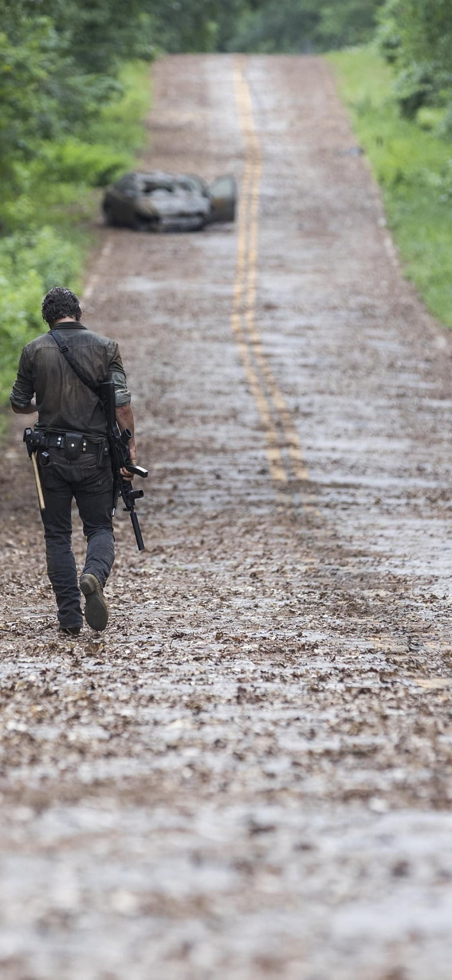 Rick Grimes Walking Down a Muddy Country Road in The Walking Dead HD phone wallpaper