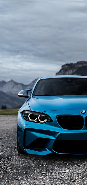 Blue BMW M2 F87 Front View on Gravel Road with Mountain Backdrop HD phone wallpaper