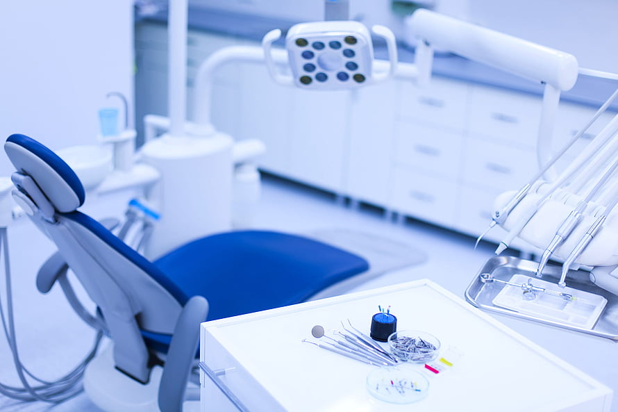 Modern Dental Clinic Interior With Blue Patient Chair And Surgical Instruments HD wallpaper