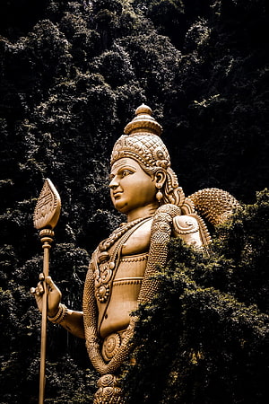 Lord Murugan Statue in Lush Forest Setting HD phone wallpaper