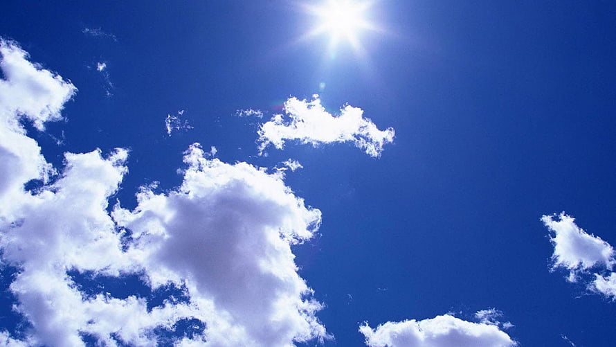 Bright Sun and Fluffy White Clouds in a Deep Blue Summer Sky HD wallpaper
