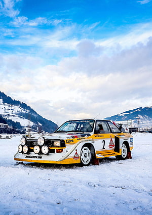 Audi Quattro S1 E2 rally car parked on snow with mountain backdrop HD phone wallpaper