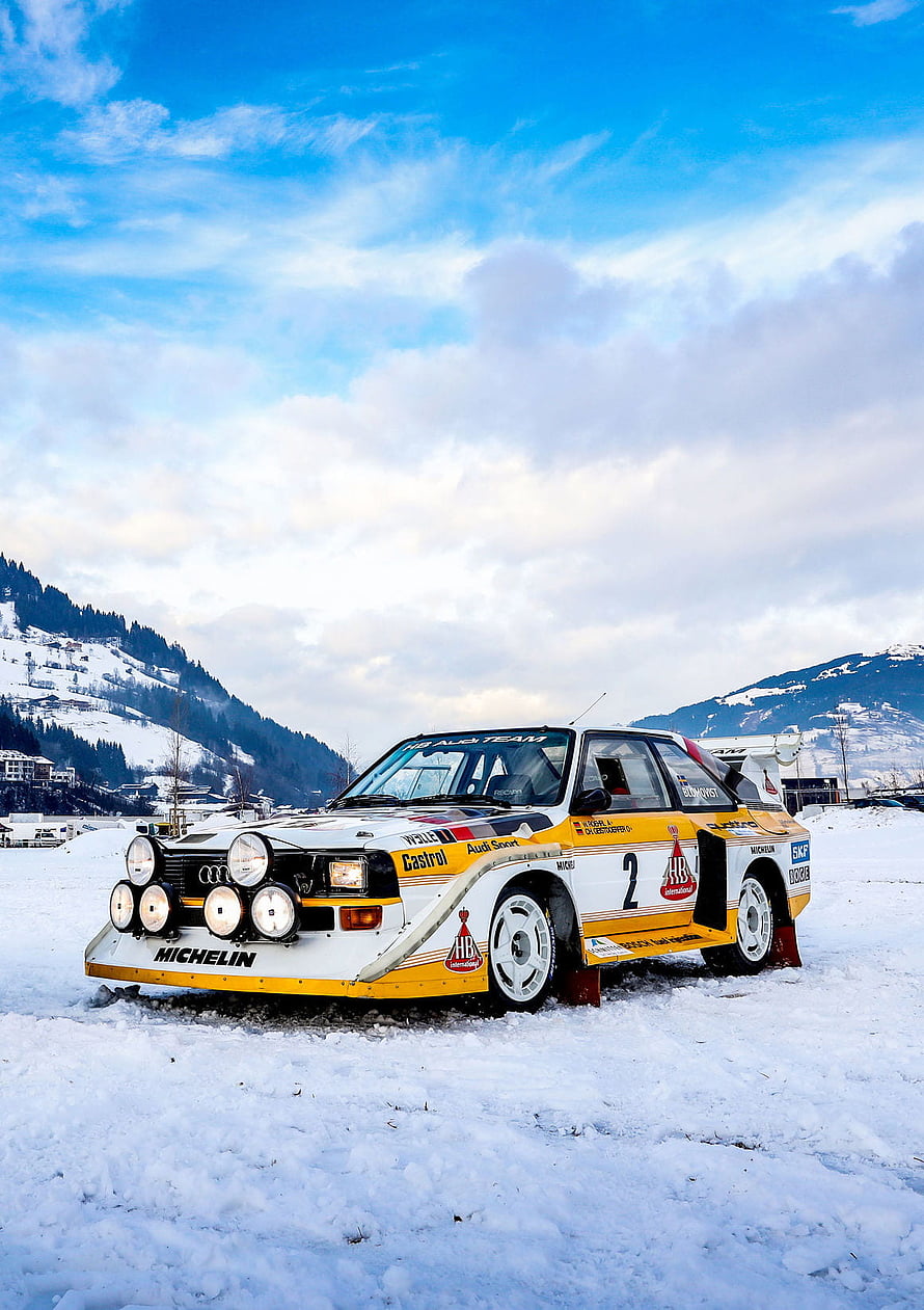 Audi Quattro S1 E2 rally car parked on snow with mountain backdrop HD phone wallpaper