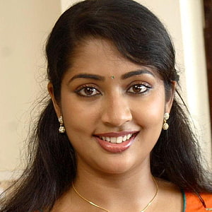 Navya Nair Portrait with Traditional Jewelry and Warm Smile HD phone wallpaper