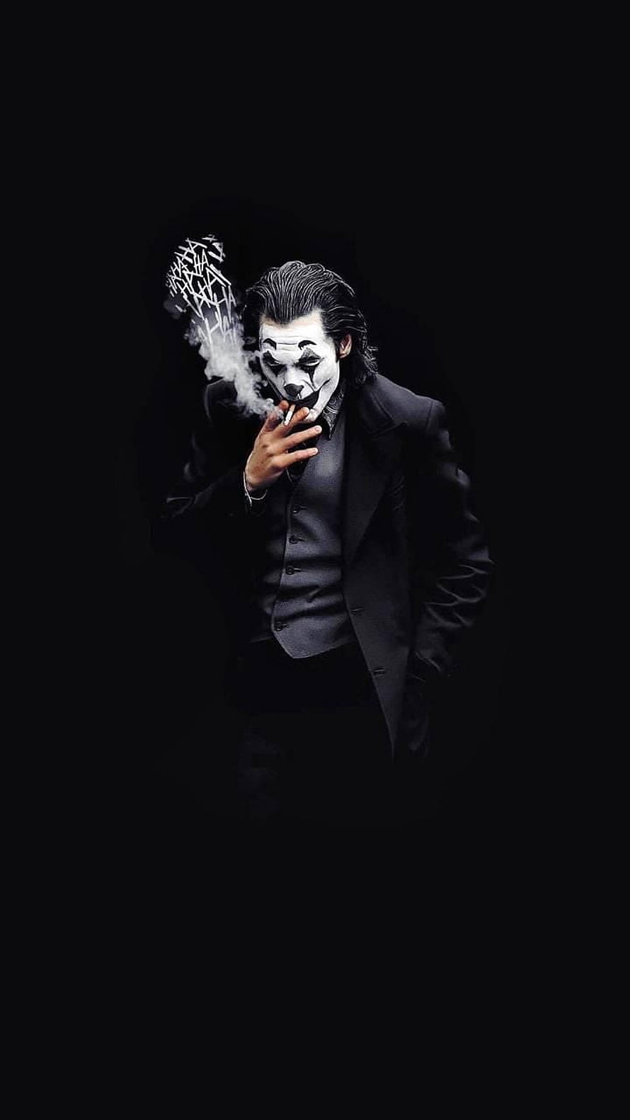 Black Joker in a dark suit smoking a cigarette with dramatic smoke against a black background HD phone wallpaper