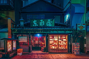 Neon-lit Japanese restaurant storefront at night with glowing display cases and traditional signage HD wallpaper