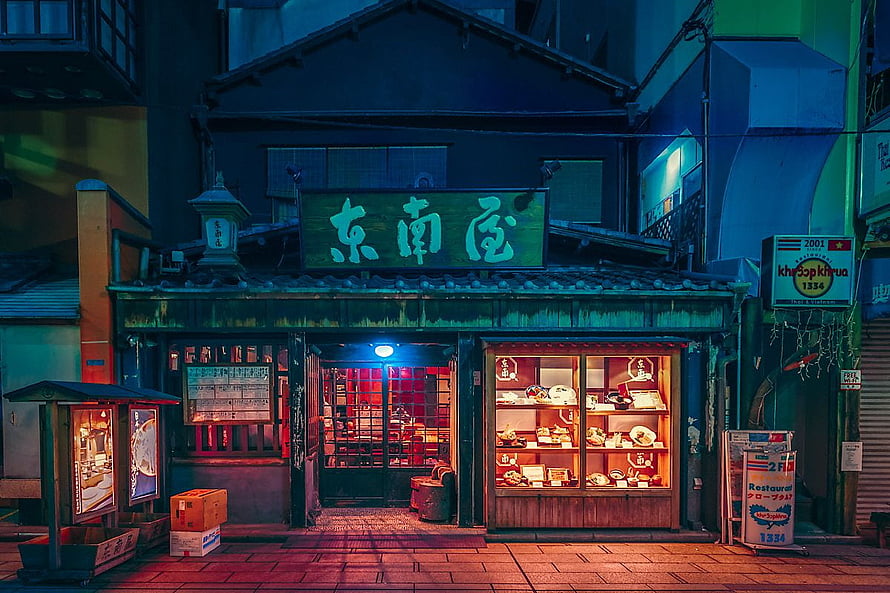 Neon-lit Japanese restaurant storefront at night with glowing display cases and traditional signage HD wallpaper