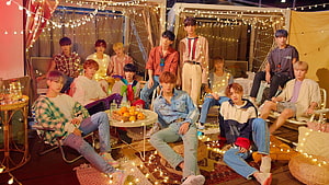 Seventeen K-pop Group in Cozy Camp Setting with String Lights and Casual Outfits HD wallpaper