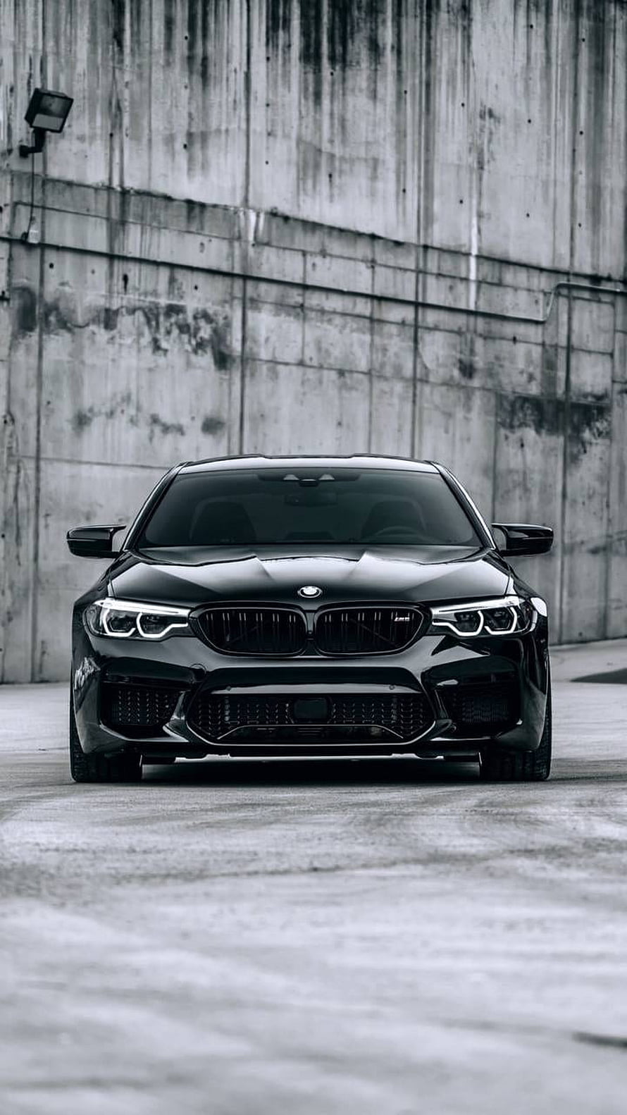 Black BMW M5 F90 Front View Against Industrial Concrete Wall HD phone wallpaper