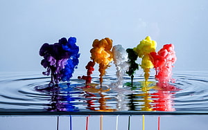 Vibrant Paint Drops Creating Colorful Ink Clouds in Water HD wallpaper