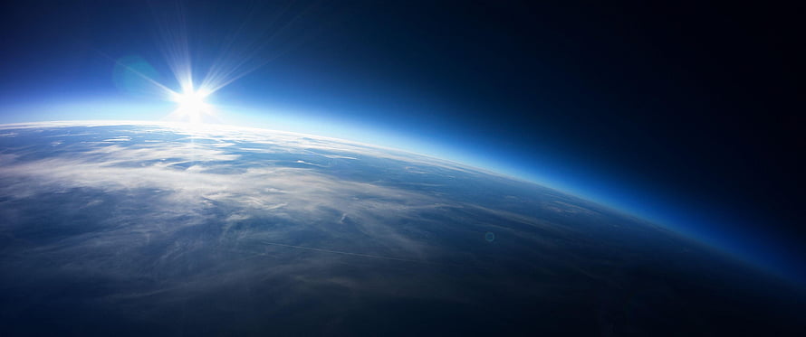 Sunrise Over Earth's Curved Horizon From Orbit With Clouds and Atmosphere Glow HD wallpaper