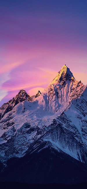 Majestic Snow-Capped Mountain Peak Bathed in Golden Sunset Light Against a Vibrant Purple Sky HD phone wallpaper