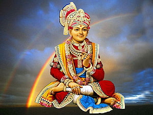 Swaminarayan seated in meditation with ornate crown and traditional robes against a dramatic sky with a rainbow HD wallpaper