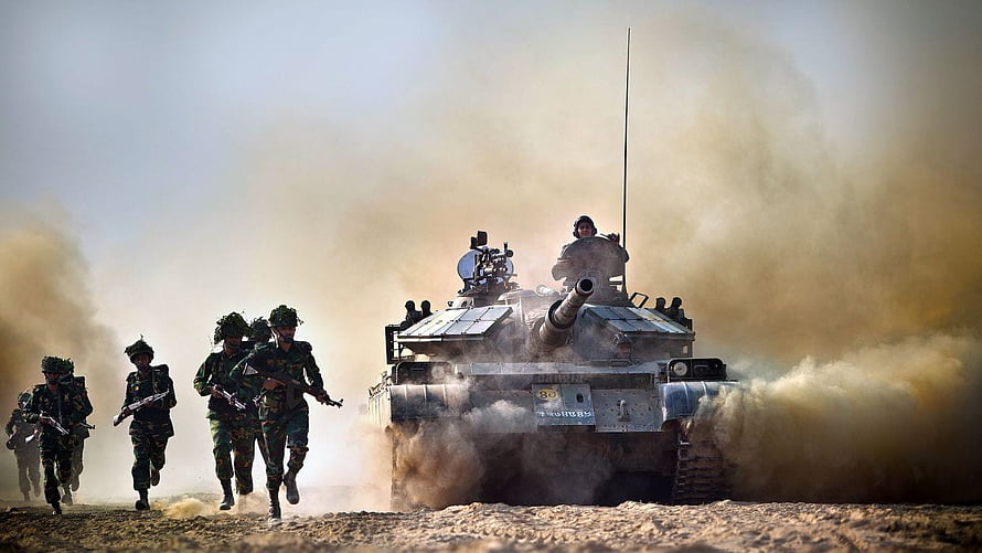 Bangladesh Army soldiers sprinting alongside a main battle tank in a dusty field HD wallpaper