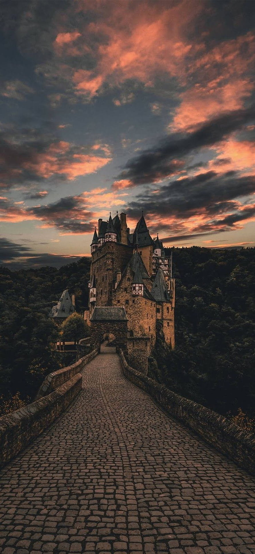 Cobblestone Bridge Leading to a Medieval Castle at Sunset HD phone wallpaper