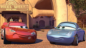 Lightning McQueen and Sally Carrera at the Wheel Well Motor Court in Cars 3 HD wallpaper
