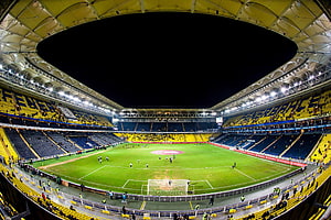 Fenerbahce Stadium Interior with Yellow and Blue Seating at Night HD wallpaper