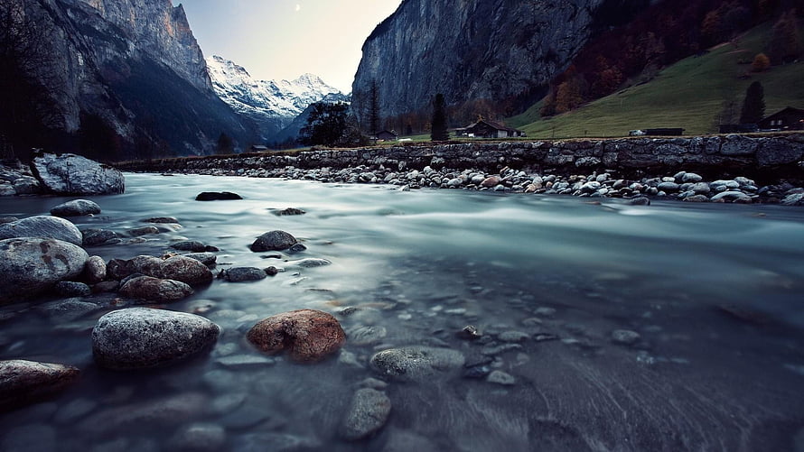 Alpine River Valley with Snow-Capped Peaks and Misty Water Flow HD wallpaper