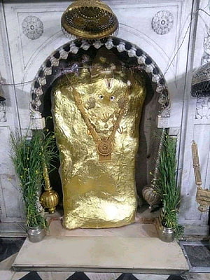 Mehandipur Balaji Temple Shrine with Golden Idol and Sacred Offerings HD phone wallpaper