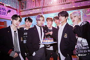 ENHYPEN Members Celebrating with Cake in Festive Studio Setting HD wallpaper