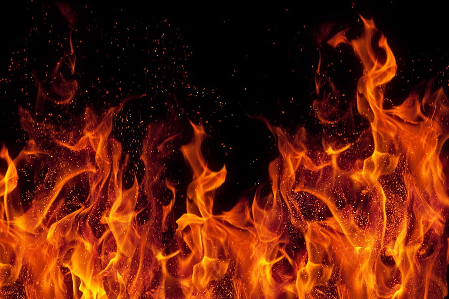 Intense Orange Fire Flames With Rising Sparks Against a Dark Black Background HD wallpaper
