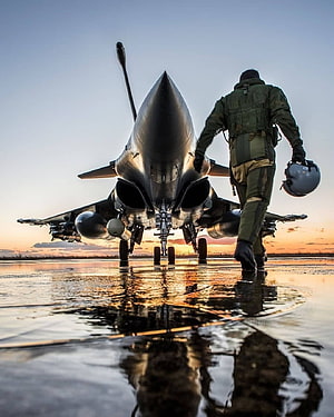 Fighter Pilot Walking Toward Indian Air Force Jet on Wet Runway at Sunset HD phone wallpaper