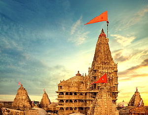 Dwarkadhish Temple at Golden Hour with Red Flags and Intricate Carvings HD wallpaper