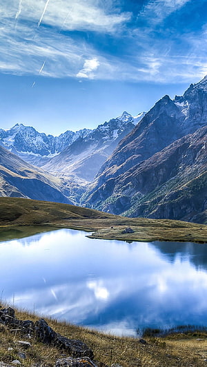 Alpine Mountain Lake with Snow-Capped Peaks and Mirror Reflection Under Blue Sky HD phone wallpaper