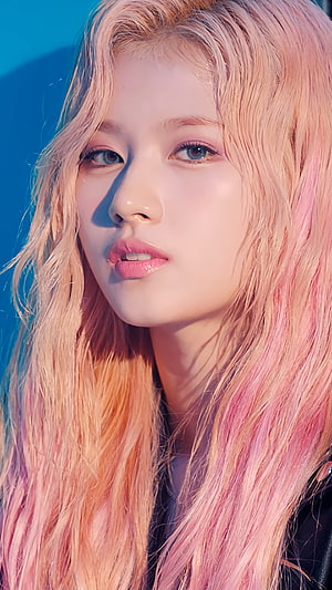 Sana from TWICE with pastel pink and peach ombre hair in a close-up portrait HD phone wallpaper